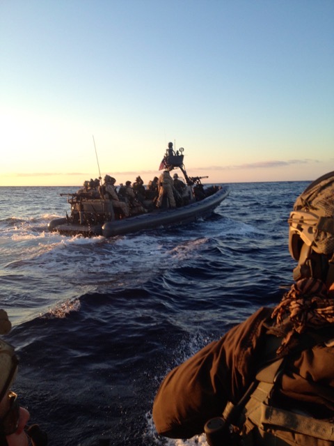 A Piloteer team on the water at dusk, operating together from rigid-hull boats